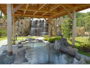 a pond in a garden with a waterfall at KAISYU - Vacation STAY 42700v in Kyotango