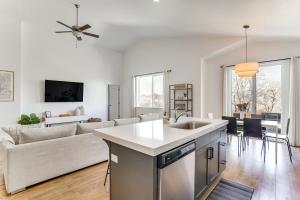a white kitchen and living room with a couch at Vineyard Retreat with Gas Grill Near Utah Lake! in Vineyard