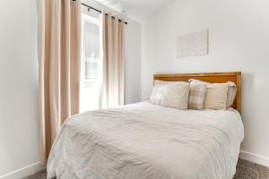 a white bedroom with a bed with a window at Vineyard Retreat with Gas Grill Near Utah Lake! in Vineyard