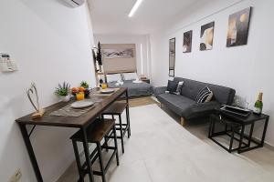 a living room with a table and a couch at DUOMO City Center Suites in Heraklio Town