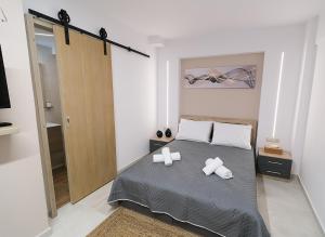 a bedroom with a bed with two crosses on it at DUOMO City Center Suites in Heraklio Town