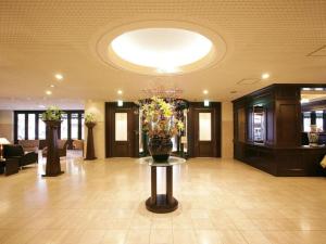 a lobby with a vase of flowers on a table at Suikoyen Hotel - Vacation STAY 53816v in Kurume