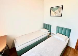 a room with two beds and a picture on the wall at Fregata in Łeba