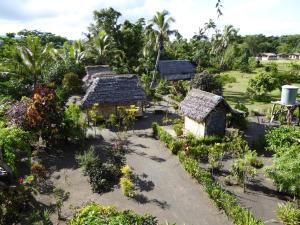 an aerial view of a garden with small buildings at Tanna tree house and bangalows in Lénakel