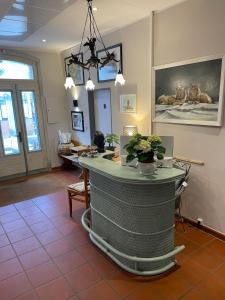 a lobby with a bar in the middle of a room at Aparthotel Domizil in Borkum