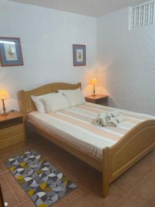 a bedroom with a dog laying on a bed at Olhao Apartment in Olhão