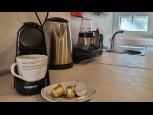 a kitchen counter top with a coffee maker and a cup at Mobile home JOY in Biograd na Moru
