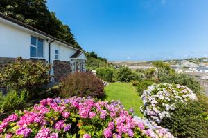 a garden of flowers in front of a house at Beach Haven in Wadebridge