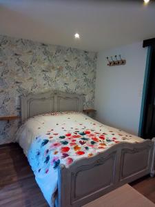 ein Schlafzimmer mit einem Bett mit Blumen darauf in der Unterkunft Studio calme in Pleine-Fougères