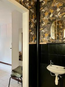 a bathroom with a sink and a mirror at Petit Havre in Namur +23 photos