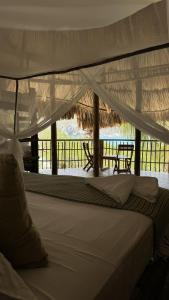 a bed with a white canopy in a resort at Wachakyta Ecolodge in Calabazo