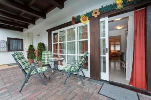 a patio with chairs and a table in front of a house at Ferienwohnung Pali in Sankt Johann in Tirol