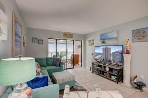 a living room with a couch and a tv at Gulf Tower 3C by Vacation Homes Collection in Gulf Shores