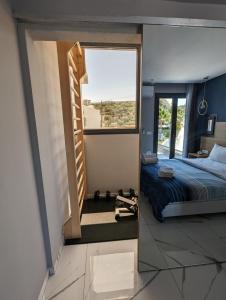a bedroom with a bed and a large mirror at Muse by the beach in Amoudara Lasithiou
