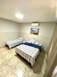 a bedroom with two beds in a room at Hotel Vale do Sol in Três Lagoas