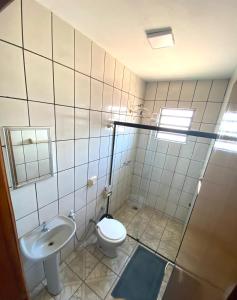 a bathroom with a toilet and a sink at Hotel Vale do Sol in Três Lagoas +23 photos