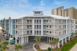 an aerial view of a white building with palm trees at Sea Glass 316 by Vacation Homes Collection in Gulf Shores