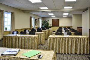 a row of tables in a room with chairs at Cresthill Suites Syracuse in East Syracuse