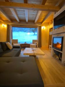 a living room with a couch and a fireplace at Granero Colibita in Colibiţa