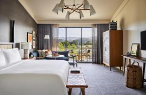 a hotel room with a bed and a living room at Rosewood Sand Hill in Menlo Park