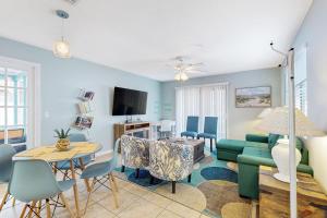a living room with a couch and a table at Centrally located dog-friendly home with beach gear & patio - snowbird-friendly in Palm Coast