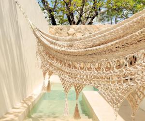 a hammock hanging from the side of a building at Casa Colibri Central Villa with Private Pool and Tub Merida in Mérida
