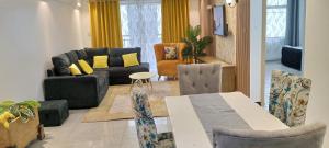 ein Wohnzimmer mit einem Sofa, einem Tisch und Stühlen in der Unterkunft City Haven Accommodation-Two bedroom Apartment in Nairobi