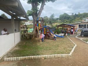 a group of children playing in a playground at Finca Villa Mariana in Papagalleros