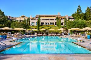 a large swimming pool with chairs and umbrellas at Rosewood Sand Hill in Menlo Park