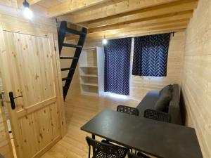 a room with a couch and a table and a staircase at Resort Pirates in Dziwnow for 4 persons in Dziwnów