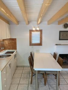 a kitchen with a table and chairs in a room at Pirinas Meteora in Kalabaka