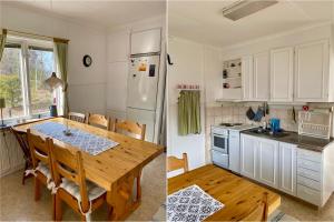 cocina con mesa de comedor y cocina con armarios blancos en Tömsagården, en Järvsö