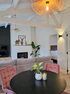 a living room with a table and a couch at vakantiewoning 266 in De Panne