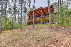 a house on top of a hill in the woods at Blue Ridge Cabin with Hot Tub, Deck and Mountain Views in Blue Ridge