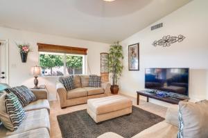 a living room with two couches and a flat screen tv at Yuma Family Home with Covered Patio and Grill! in Yuma