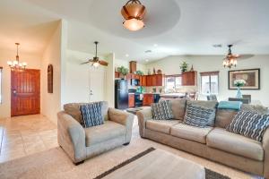 a living room with two couches and a kitchen at Yuma Family Home with Covered Patio and Grill! in Yuma