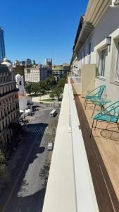 a balcony with two chairs sitting on top of a building at Downtown Buenos Aires. THE POINT in Buenos Aires