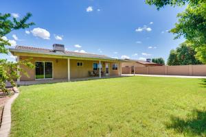 a house with a large yard at Yuma Family Home with Covered Patio and Grill! in Yuma