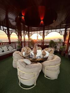 a room with a table and chairs and a balcony at Arabesque Dome Roof Gardens in Luxor