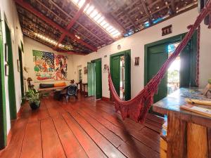 a room with a hammock in the middle of a room at HI Hostel Chapada in Lençóis