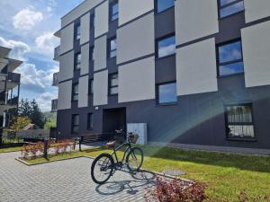 a bike parked in front of a building at Apartament Sunray in Krakow