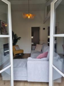 a living room with a couch and a living room with a couch at vakantiewoning 266 in De Panne