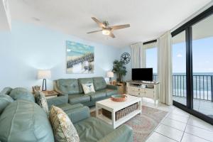 a living room with a couch and a tv at Phoenix VIII 81201 by Vacation Homes Collection in Orange Beach