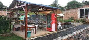 a gazebo with a table and a playground at Finca Villa Mariana in Papagalleros