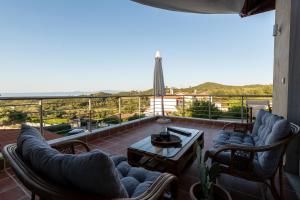 a balcony with chairs and a table and a view at Aethra Terrace - Sea View Retreat in Hanioti