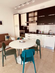 a kitchen and a table and chairs in a room at Le Stanze di Marco in Santa Caterina di Nardò