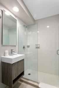 a bathroom with a sink and a glass shower at Hotel Sheldon in Hollywood