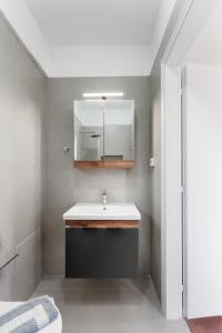 a bathroom with a sink and a mirror at Villa Erato in Tsoukalades