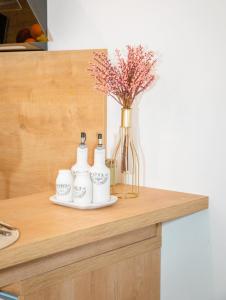 a counter with a vase of flowers and a vase of flowers at Studio apartman MATEO in Blace