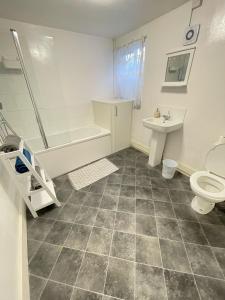 a bathroom with a shower toilet and a sink at City Heights inquire for FREE Parking in Kent